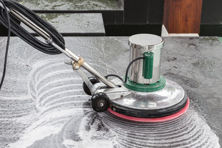Exterior black stone floor cleaning with polishing machine and chemicalの写真素材
