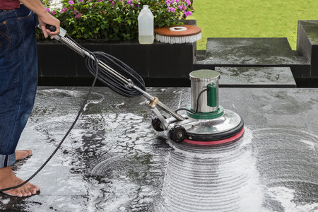 Exterior black stone floor cleaning with polishing machine and chemicalの写真素材