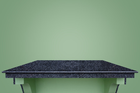 Empty top of black natural stone counter on green wall background.の写真素材