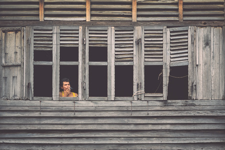 PHUKET, THAILAND - OCTOBER 1 : The unidentified people standing at window in the old wood house in Phuket old town while renovation in Phuket on October 1, 2016.のeditorial素材