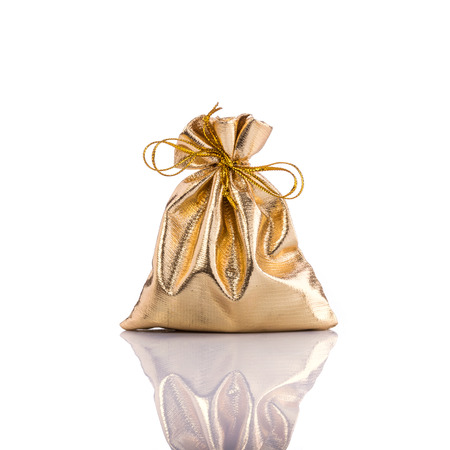 Golden bag for coin. Studio shot isolated on white backgroundの写真素材