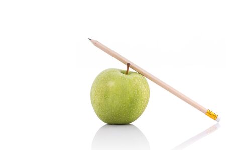 Green apple and pencil. Studio shot isolated on white backgroundの写真素材