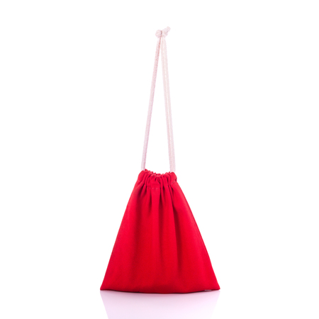 Red cotton bag for coin. Studio shot isolated on white backgroundの写真素材
