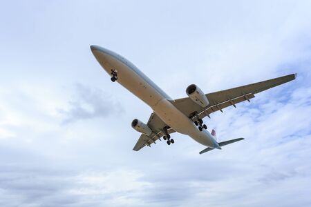 Airplane flying under blue sky and white cloud in Phuket, Thailandの写真素材
