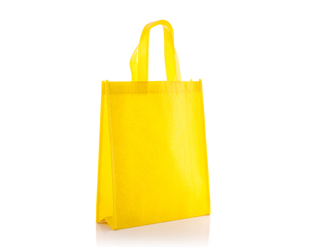 Yellow cotton bag. Studio shot isolated on white backgroundの写真素材