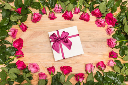 Top view fresh pink rose flower and gift box on wooden deck. For love or valentine day conceptの写真素材