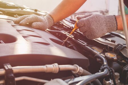 Hand of technician checking or fixing engine of modern carの写真素材