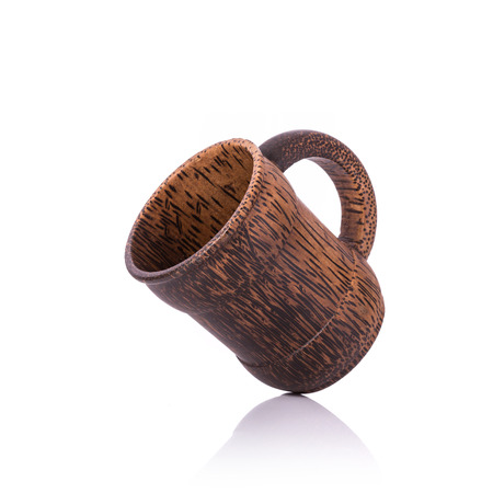Brown coffee cup made from palm wood. Studio shot isolated on white backgroundの写真素材