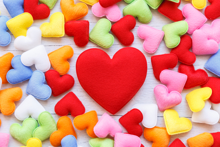 Top view colorful heart shape on white wooden plank background. For love or valentine day conceptの写真素材