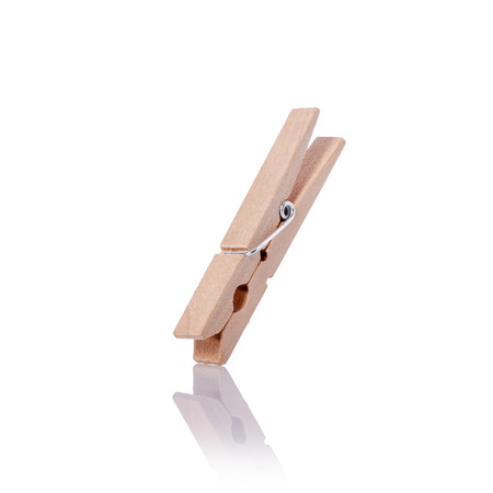 Wooden clothes pin. Studio shot isolated on white backgroundの写真素材