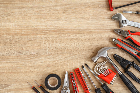 Close up new of assorted work tools on wood with copy space for text