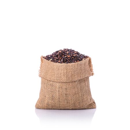 Close up Thai black sticky rice in small sack. Studio shot isolated on white backgroundの写真素材