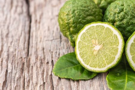 Close up slice green fresh Bergamot fruit on wooden table backgroundの写真素材