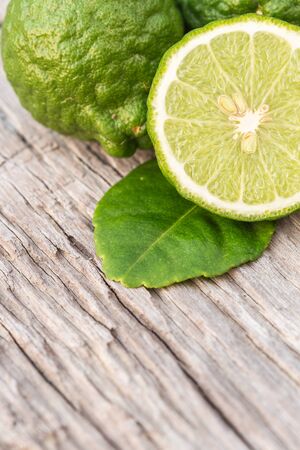 Close up slice green fresh Bergamot fruit on wooden table backgroundの写真素材