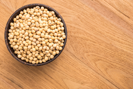 Top view soybean in wooden bowl put on wooden plank backgroundの写真素材