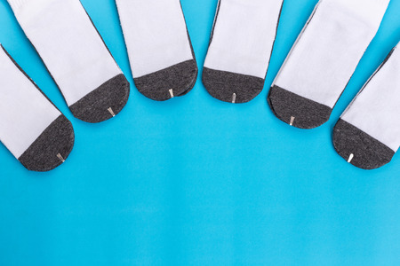 Top view new white student sock on blue background with free space for designの写真素材