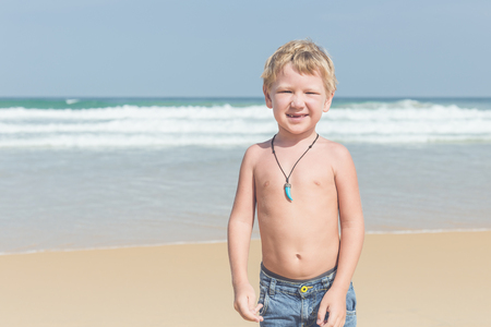 Caucasian boy from europe with happy and relax time on the tropical beach at Karon, Phuket province southern of Thailandの写真素材