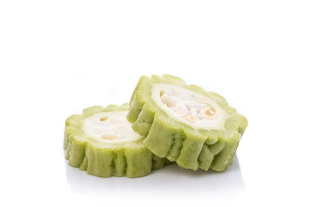 Close up fresh slice green bitter gourd. Studio shot isolated on white backgroundの写真素材
