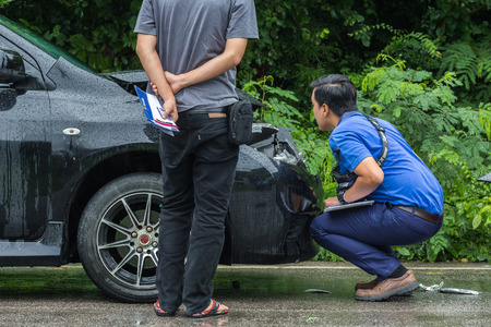 KAMPHAENG PHET, THAILAND - JULY 17 : An unidentified people checking front of black car which got damaged by accident on the road on July 17, 2017 in Kamphaeng Phet, Thailand.のeditorial素材
