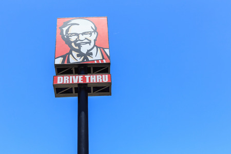 PHUKET, THAILAND - JULY 28, 2017 : KFC logo on blue sky. KFC is a fast food restaurant chain that specializes in fried chicken.のeditorial素材