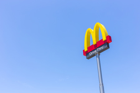 PHUKET, THAILAND - JULY 28, 2017 : McDonalds logo on blue sky McDonald's Corporation is the world's largest chain of hamburger fast food restaurants.のeditorial素材