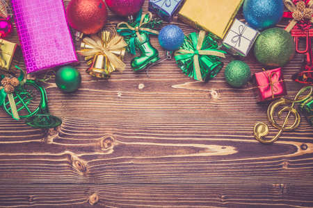 New year or Christmas decoration for holiday concept on brown wooden board. Top view with empty space for text and design. Vintage filter effectの写真素材