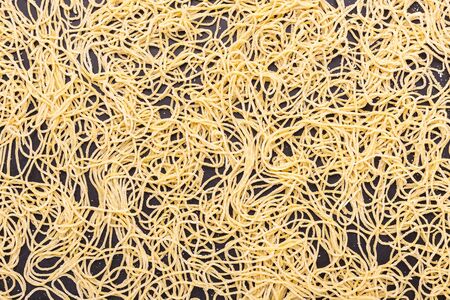 Close up traditional Thai yellow noodle on black stone table backgroundの写真素材