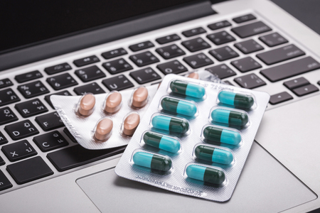 Close up of pills on a laptop, Healthy and hard work concept. Selective focusの写真素材