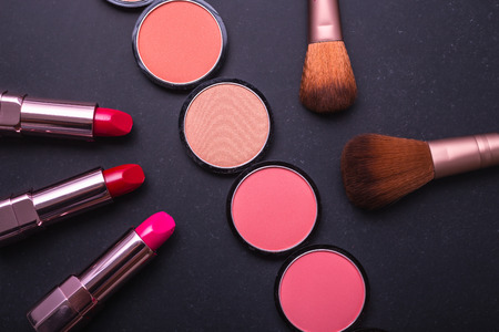 Set of decorative cosmetics and soft brush on stone backgroundの写真素材