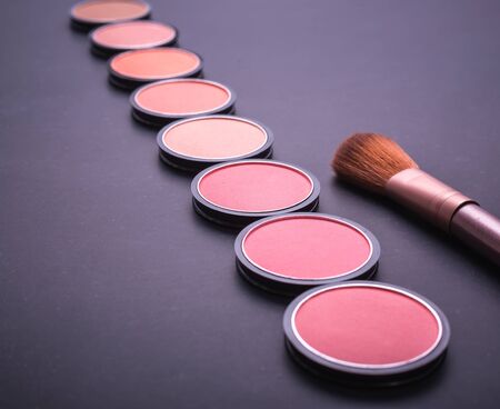 Set of decorative cosmetics and soft brush on stone backgroundの写真素材