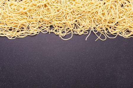 Close up traditional Thai yellow noodle on black stone table backgroundの写真素材