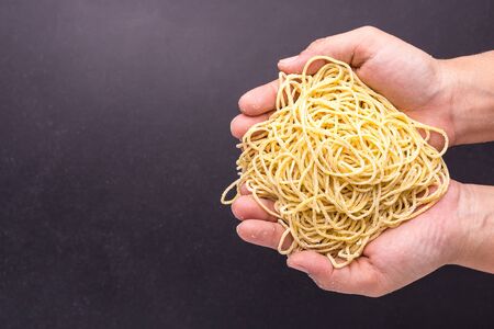 Close up traditional Thai yellow noodle on black stone table backgroundの写真素材