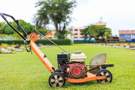 A man mowing the grass in the public garden. Outdoor workingの写真素材