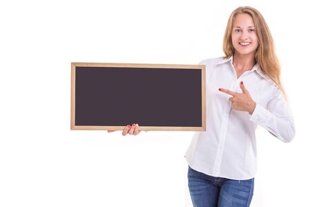 Beautiful caucasian woman in white shirt and holding blank blackboard. Studio shooting isolated on white backgroundの写真素材
