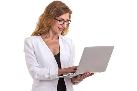Beautiful caucasian businesswoman wear glasses and using modern laptop. Studio shot isolated on white background. Working conceptの写真素材