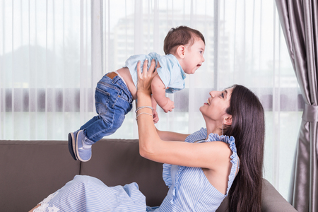 Mother playing with her son. Good health baby smiling. Caucasian kid and Happy family concept. Focus...