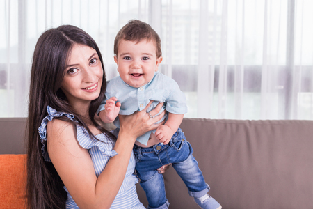 Mother playing with her son. Good health baby smiling. Caucasian kid and Happy family concept. Focus...
