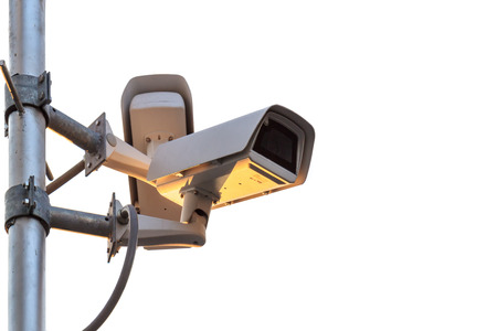 Security CCTV camera set up on the metal pole at public area and isolated on white background