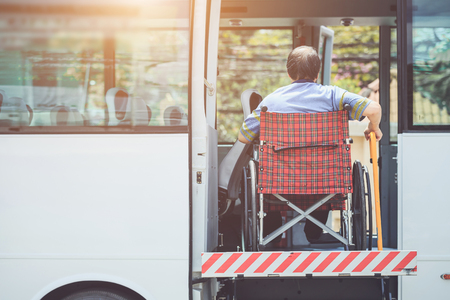 Disabled bus concept : Disabled people sitting on wheelchair and going to the public busの写真素材