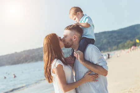 Family on the beach concept, Father, Mother and Kid with relax activity, walking and playing on the tropical beachの写真素材