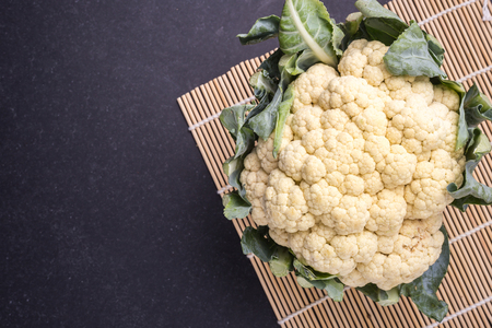 Top view fresh Cauliflower on black stone backgroundの写真素材