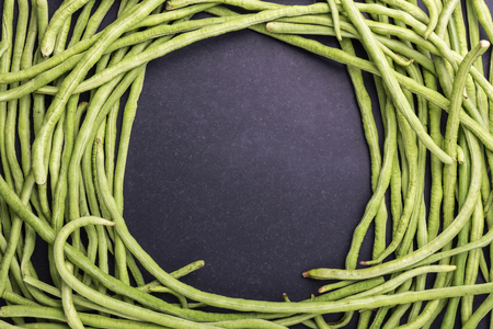 Top view fresh green cowpea or Asparagus bean on black stone backgroundの写真素材