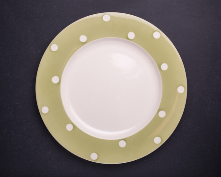 Top view empty white new ceramic kitchen dish on black stone table backgroundの写真素材