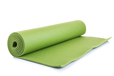 New green soft Yoga mat. Studio shot isolated on white backgroundの写真素材