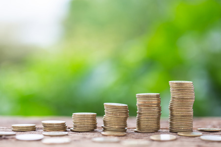 Different level of coin stack on blur background. Business success or money growing concept