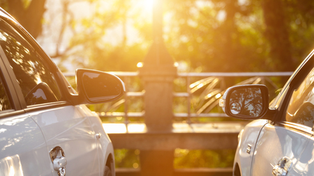 Two of new silver car parking in the parking spaceの写真素材