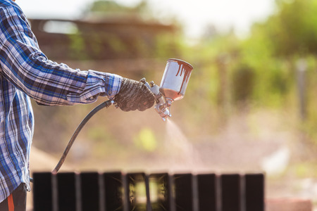 Construction worker spraying paint to steel pipe to prevent the rust on the surfaceの写真素材