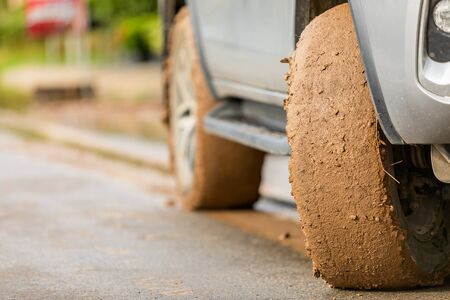 Wheel of SUV car with dirty from mud and clay. Parking on the road for safe drive conceptの写真素材