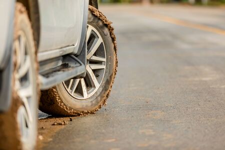 Wheel of SUV car with dirty from mud and clay. Parking on the road for safe drive conceptの写真素材