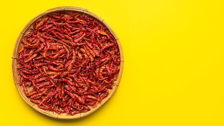 Top view dry red hot Thai chilli yellow paper background. Food conceptの写真素材
